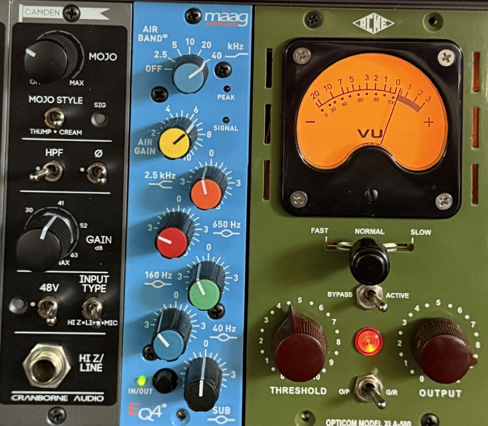 Close on the 500-series rack: Cranborne Camden preamp, Maag EQ4 and an ACME Opticom compressor with a lit VU meter.