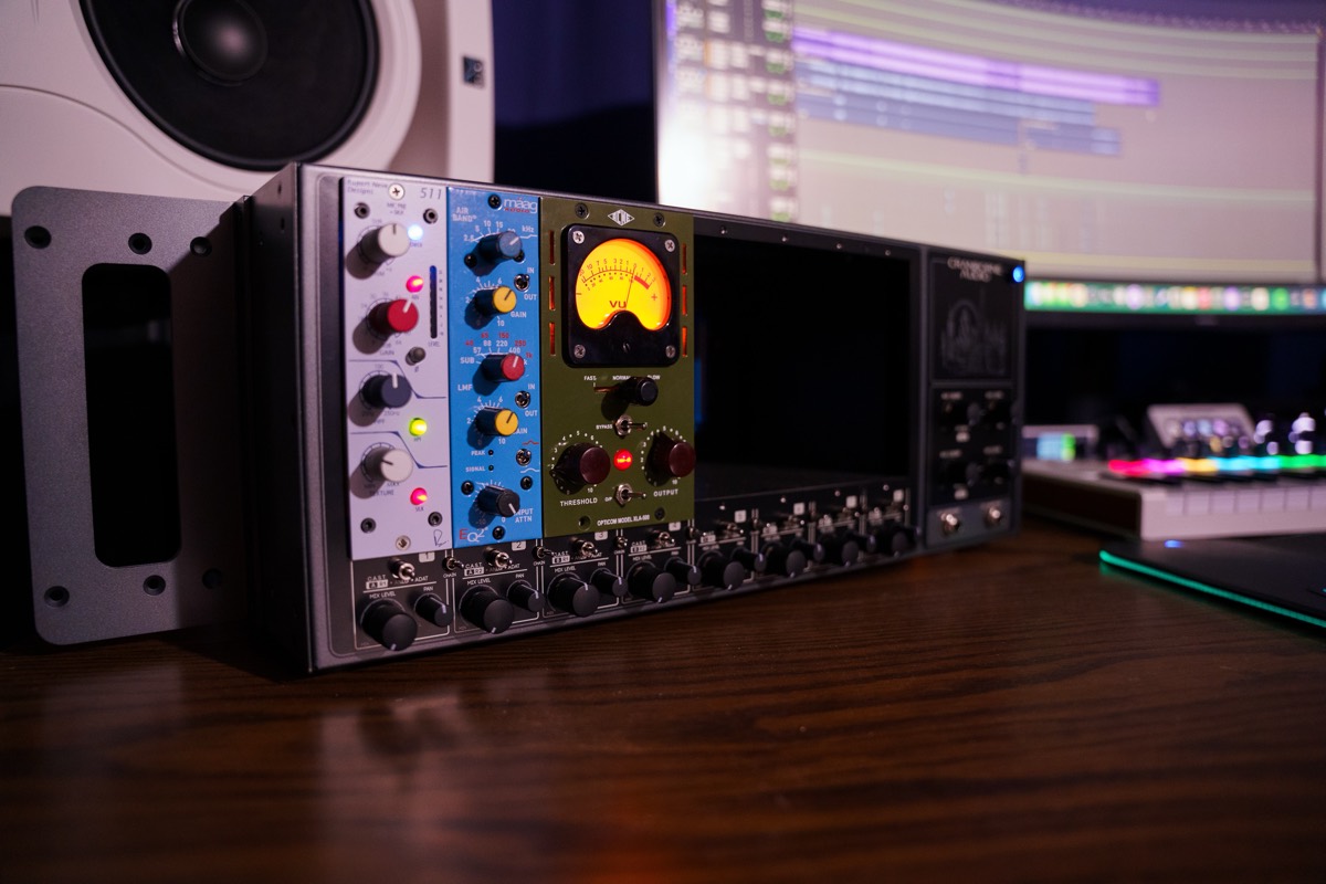 The 500-series rack at Stratosphere Records: Cranborne Camden preamps, a Maag EQ4 and an ACME Opticom compressor with its VU meter lit, the session running on the screens behind.