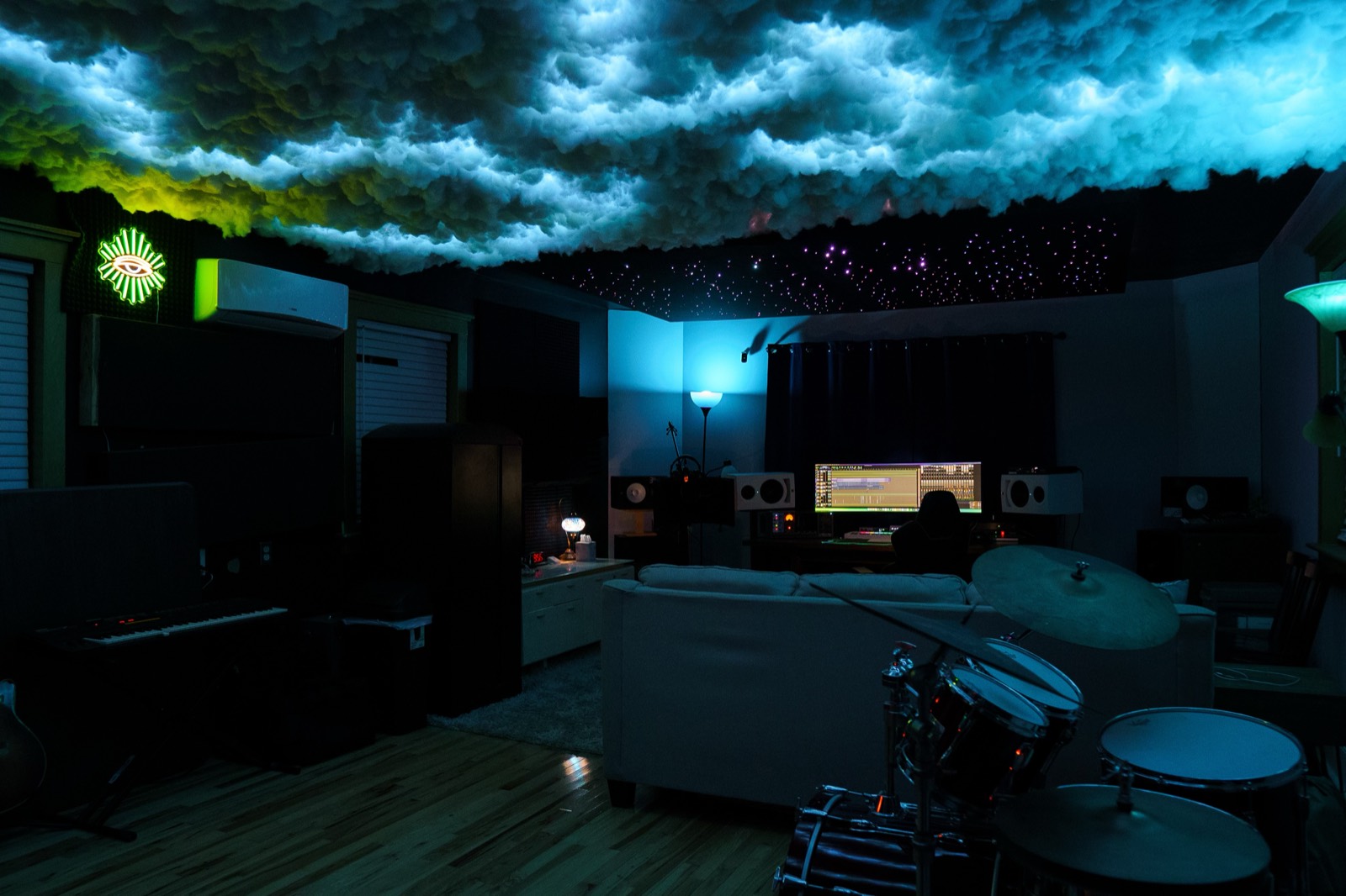 The live room at Stratosphere Records: drums, keys and the desk beyond, under the lit cloud ceiling.